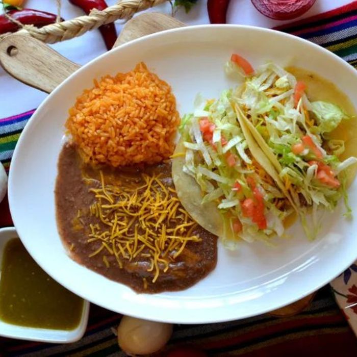 Image of a plate of tacos, beans and rice from Navarro’s Mexican Takeout in Muskegon Heights, Michigan.